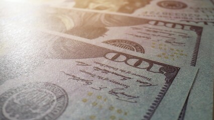 Detailed macro of numerous American one hundred dollar notes, highlighting their fine features....