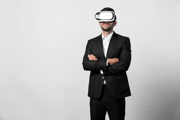 Smart business man crossing arms and standing with folded arm at white background. Professional manager looking at financial graph by using technology innovation to visit enter metaverse. Deviation.