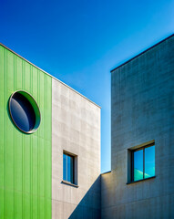 The building has geometric shapes and is painted in contrasting colors.
