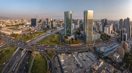 Aerial view of the intersection of Javier Prado Avenue and Via Expresa in San Isidro, Lima, Peru. The image captures the bustling urban landscape, and modern skyscrapers surrounding the area.