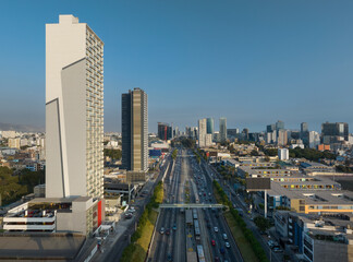 Sunlit afternoon view of buildings along the Via Expresa in La Victoria district, Lima, Peru. The...