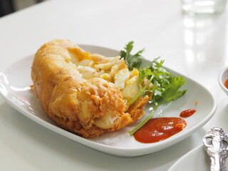 Thai style crab omelet, egg yellow food on white plate