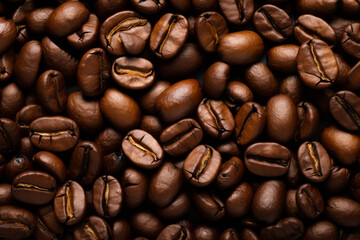 Fototapeta premium Pile of coffee beans with some brown spots on them.