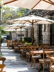 Outdoor Cafe Patio with White Umbrellas and Wooden Tables