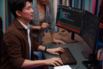 IT developers discussing with point to intelligent website development coder system running data...