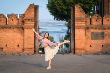 Beautiful girl ballerina dancing. Ballerina Performance Street Show in the morning at Tha Phae Gate is the Ancient Historical Gate a tourist attraction in Chiang Mai, Thailand.