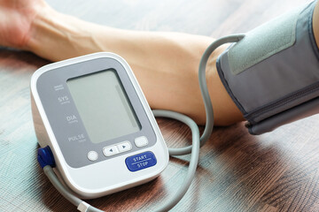 Man check blood pressure monitor and heart rate monitor with digital pressure gauge. Health care and Medical concept	