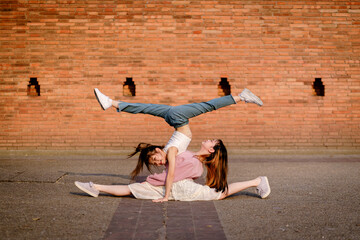 Beautiful girls perform a synchronized acrobatic pose. Performance Street Show at Tha Phae Gate the...