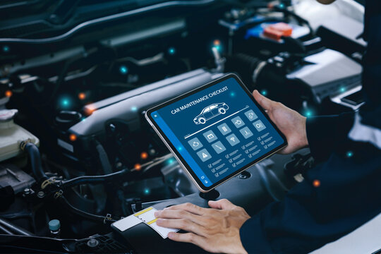 car service and checking concept. Hand of a mechanic holding the tablet for maintenance checklist vehicle, Software for manager check to repair, technology checkup automotive. Customer service concept