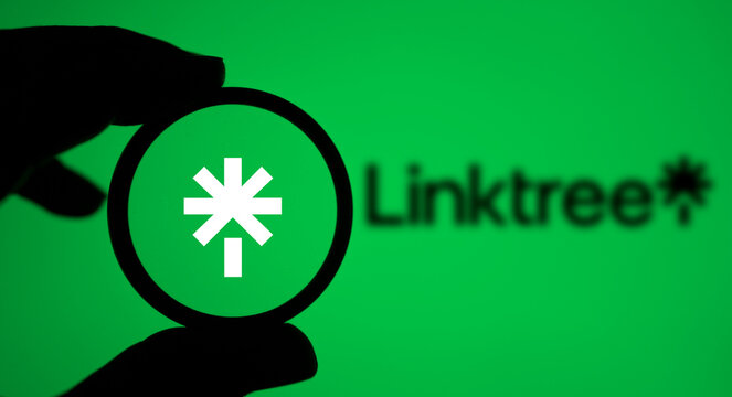 Dhaka, Bangladesh- 24 May 2024: A person holding a magnifying glass to inspect the logo of Linktree.