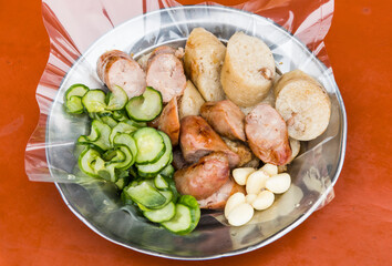Close-up of the vendors are grilling Taiwanese sausage and sticky rice (glutinous rice) sausage in the night market of Taiwan. This is one of the street snacks popular among tourists in Taiwan.