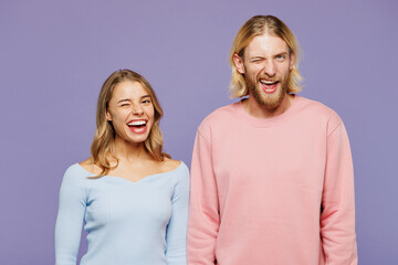 Young smiling happy cheerful fun couple two friends family man woman wear pink blue casual clothes...