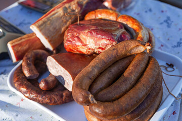A variety of smoked meat products on the counter. Delicious delicacies. Close-up.
