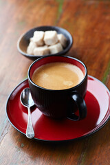 Cup of coffee on wooden background. Close up.
