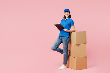 Full body delivery employee woman wearing blue cap t-shirt uniform work dealer courier hold...