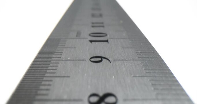Closeup of metal ruler on white background