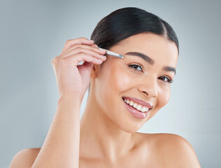 Portrait, woman and tweezers for eyebrow in studio for grooming, self care or hair removal routine....