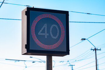 A LED road sign with a red circle surrounding the number 40, indicating a 40 kilometres per hour...