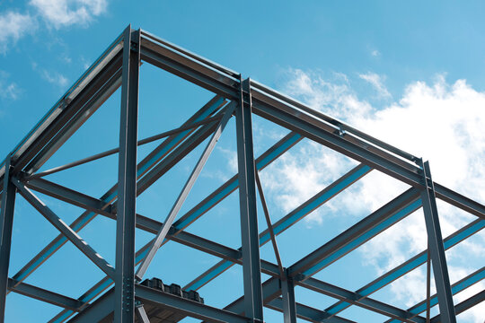 Steel frame  building under construction against blue sky