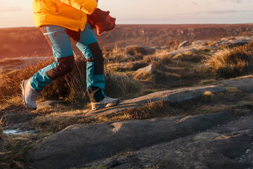 legs of woman in special boots running outside reaching destination and on  top of mountain at...