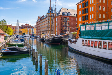 View of Copenhagen water front with boats moored in the canal. Denmark