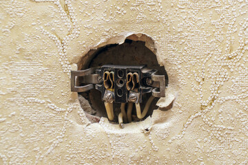 An open old non-working outlet in the wall
