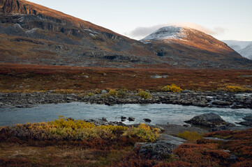 River and mountains in autumn colors at dusk, Kiruna, Sweden