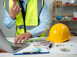 Architect or engineer using computer to work on desk, Cost calculation, Construction planning, Structural calculation, Construction cost planning, Structural design, Project presentation plan.