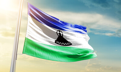 Lesotho national flag waving in beautiful sky.