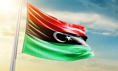 Libya national flag waving in beautiful sky.