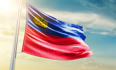 Liechtenstein national flag waving in beautiful sky.