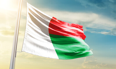 Madagascar national flag waving in beautiful sky.