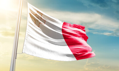 Malta national flag waving in beautiful sky.