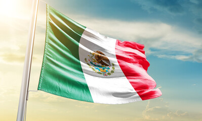 Mexico national flag waving in beautiful sky.