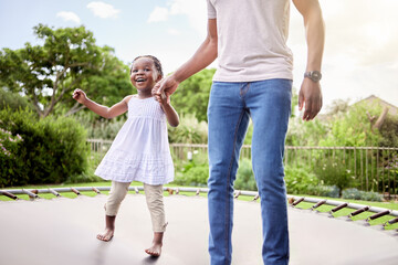 Happy, father and child on trampoline in garden, holding hands and jumping together. Fun, playing...