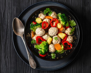 chicken meatball soup with vegetables in a bowl