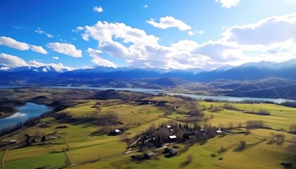 Views of fertile land surrounded by stunning green vegetation, rolling hills and mountains with clear skies in spring.