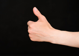 Human hand shows a thumb up gesture