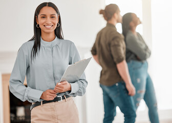 Fototapeta premium Agent, portrait and woman in house for real estate sale or couple with investment in property. Happy, realtor and show apartment or home to people with paperwork, contract and advice for mortgage