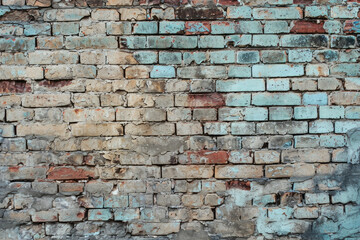 A weathered brick wall painted in vibrant blue and red colors, adding a pop of contrast to the urban landscape