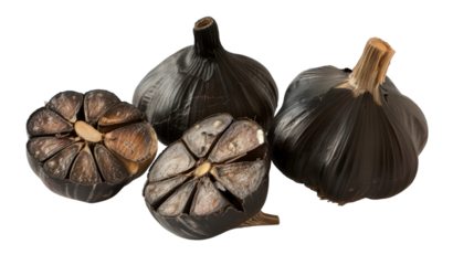 Several black garlic bulbs grouped together on a plain white background