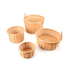 Obraz premium A set of four empty wicker baskets of varying sizes on a white background, ideal for storage or decoration.