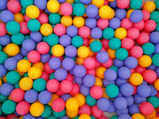 Pile of colorful little balls for children to play around 
