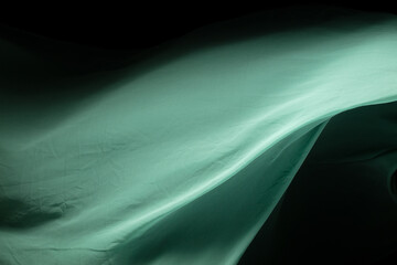 Green Organza fabric flying in curve shape, Piece of textile Green Organza fabric throw fall in...