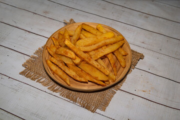 French fries served in plate isolated on napkin bangladeshi food side view on table