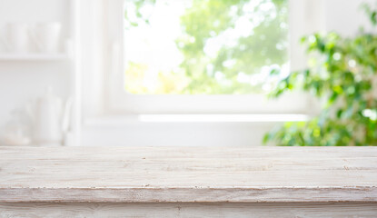 Empty wood table top on blur window sill and kitchen shelf background