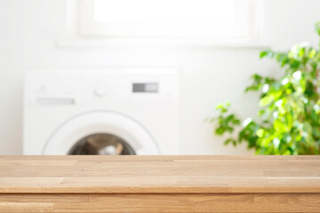 Mockup for your design with empty wooden table in blurred laundry room