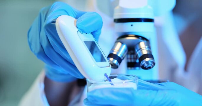 Scientist examines white powder sugar or drugs in a lab