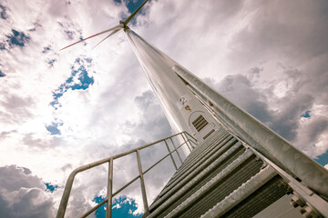 Metal stairs to the door of windmill, wind generator, turbine to generating clean renewable energy