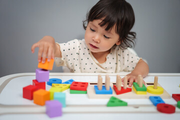 toddler baby playing block toy to stacks building cubes on table